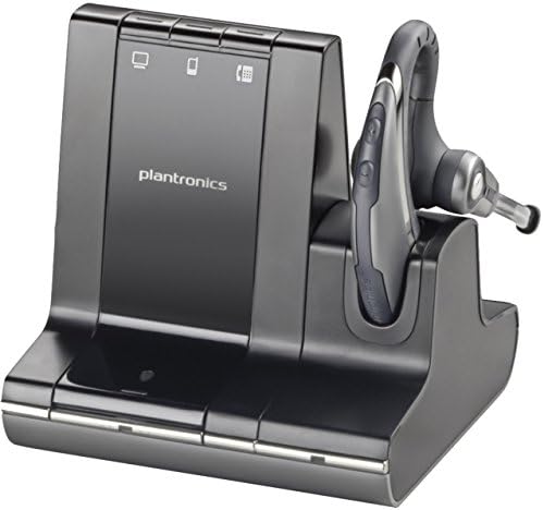 An image shows the Plantronics Savi W730-M Wireless Headset, Noise-Canceling Mic, Over-the-Ear, UC Optimized (84002-11) in black resting on its charging dock. The office wireless headset features an earpiece with a microphone boom, and the charging dock is equipped with buttons and indicator lights, making it ideal for use with Microsoft Lync.