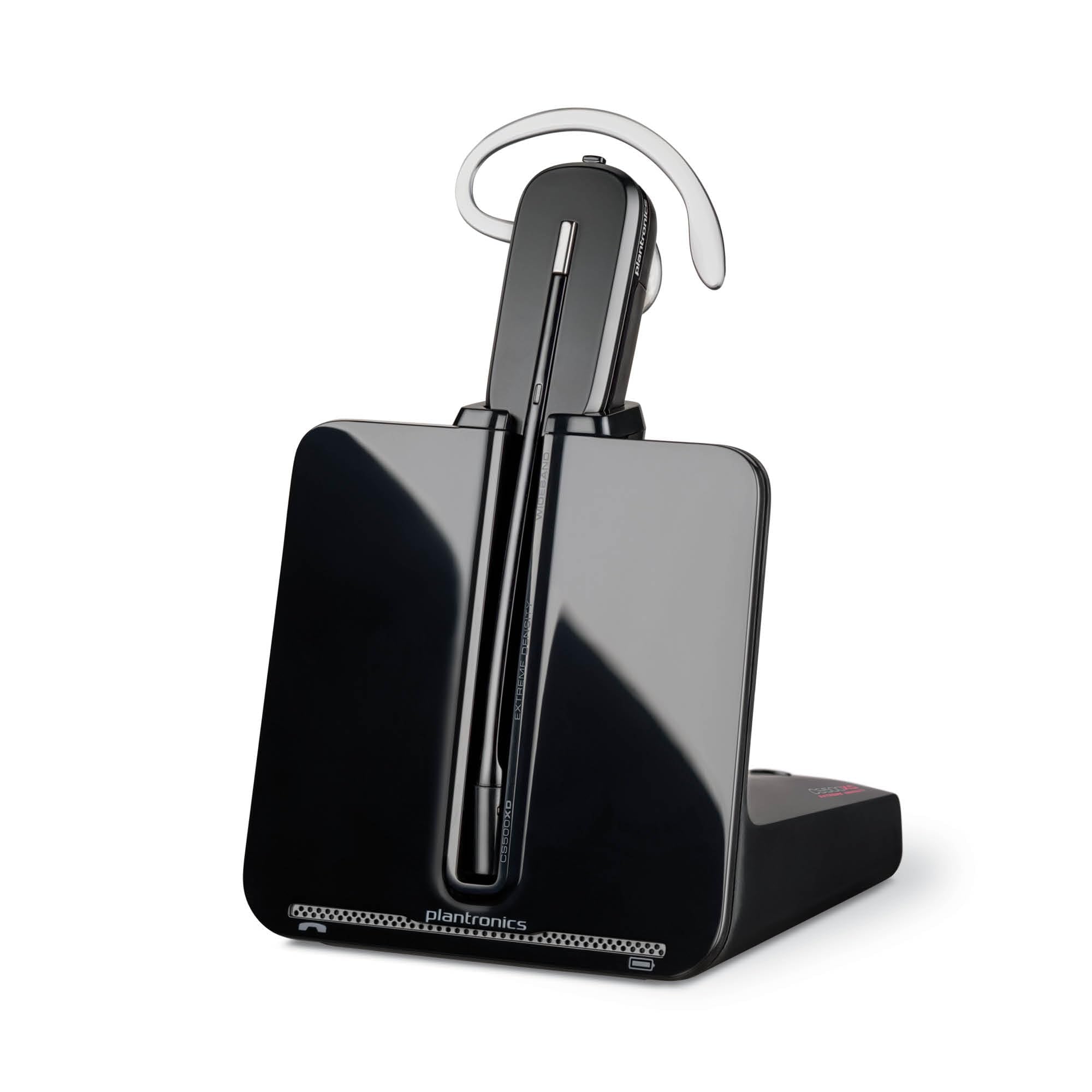 A sleek, black Poly CS540 wireless DECT headset is placed on a charging dock. The headset has a thin, curved earpiece and a slender boom microphone. The base features a subtle Poly logo at the bottom, making it an ideal office headset.