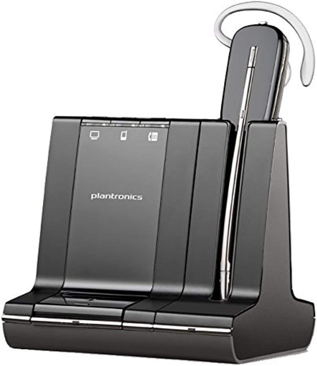 A sleek black Plantronics Savi W745 Dect Mo, Standard Packaging (Part # 86507-01) wireless headset rests on its charging base, which features user-friendly indicators. The headset, with its silver accent and secure ear hook, proudly displays the Plantronics logo at the center.