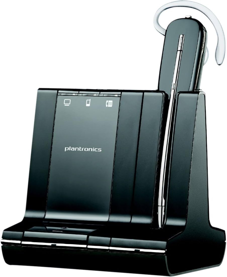 A black Plantronics Savi W745-M Wireless Headset (Model 86507-21) rests on its charging dock. The sleek design includes an LED indicator panel on the front, featuring icons for connectivity and battery status. The ear loop and noise-canceling microphone of the headset are clearly visible, making it ideal for Unified Communication applications like Microsoft Lync or Skype for Business.