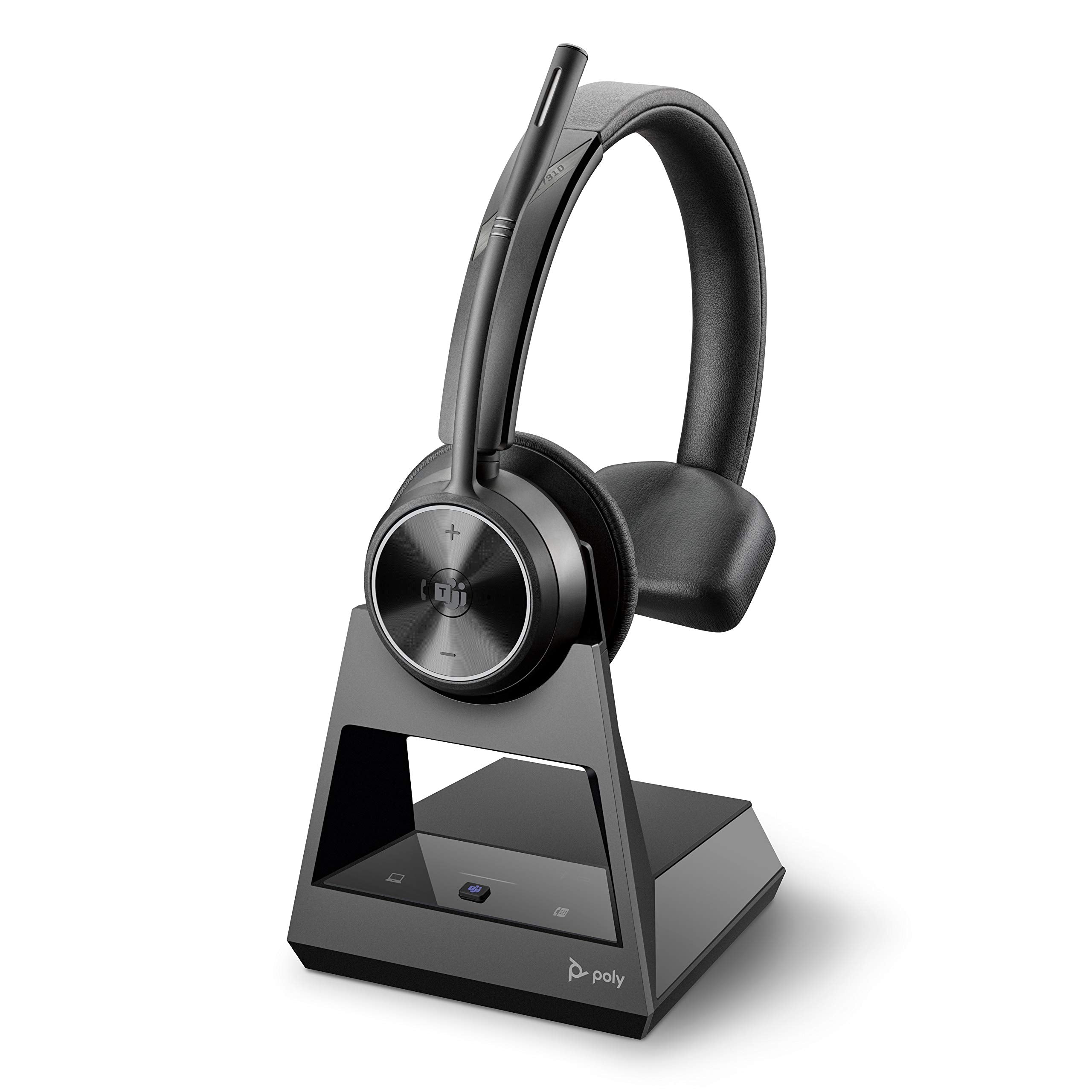 The Poly Savi 7310-M Ultra-Secure Wireless DECT Headset System, certified for Microsoft Teams, is positioned on its charging stand. This over-the-head headset from Plantronics features cushioned ear pads and volume control buttons on one ear cup. The stand has a sleek, angular design with the "Poly" brand logo prominently displayed at its base.