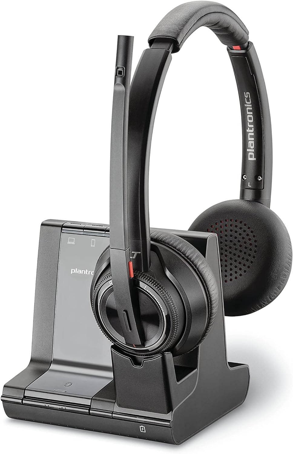 A black Plantronics wireless headset rests on its charging stand. The headset has cushioned ear pads and a microphone extension. The stand features touch controls and branding on the front. The overall design is sleek and modern.