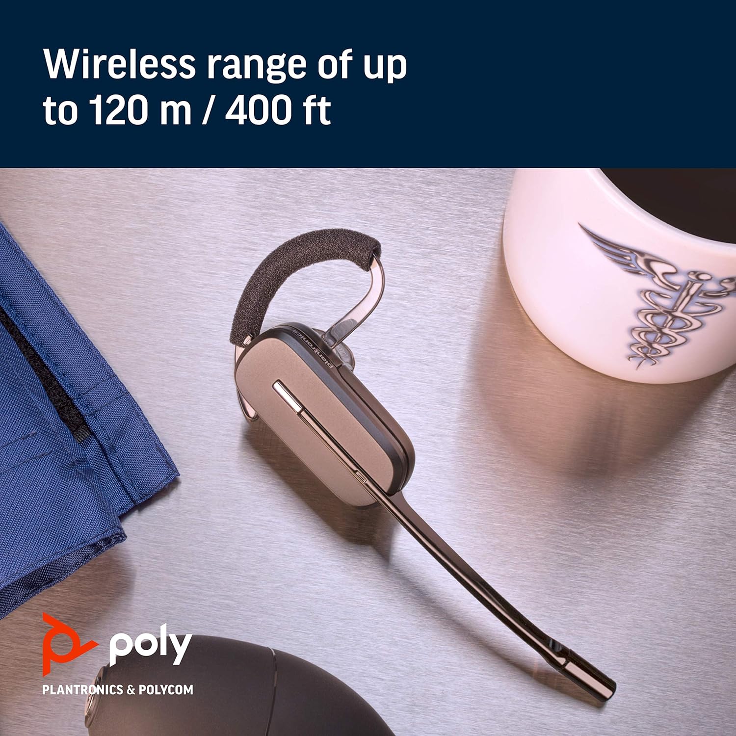 A PLANTRONICS Plantronics CS540 XD Wireless Headset is displayed on a table next to a white coffee cup with a design, a piece of blue fabric, and a black round object. The text reads, "Wireless range of up to 120 m / 400 ft.” The Poly logo and "Plantronics & Polycom" are visible in the bottom left corner.